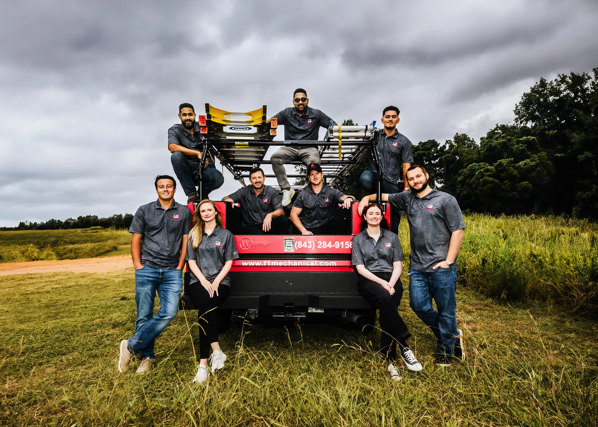 The F1 Mechanical team gathered around an F1 truck